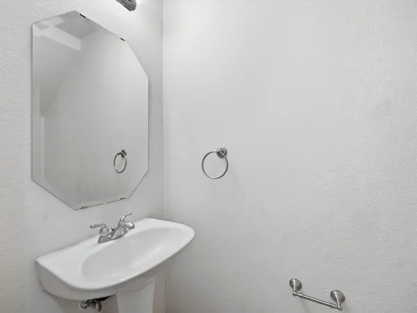 a bathroom with a sink and mirror