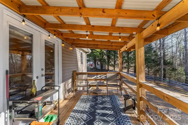a view of a patio with table and chairs and wooden floor