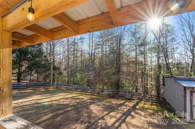 a view of a yard with wooden fence