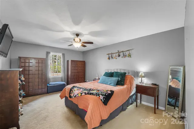 a bedroom with a large bed and a chandelier