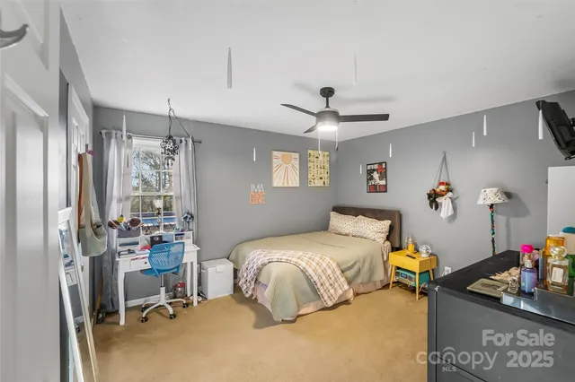a bedroom with a bed gym equipment and a window
