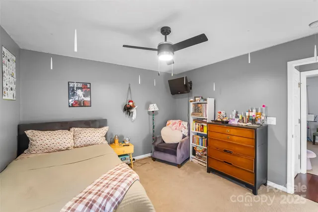 a bedroom with furniture and a chandelier