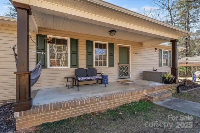 a view of a house with backyard sitting area and garden