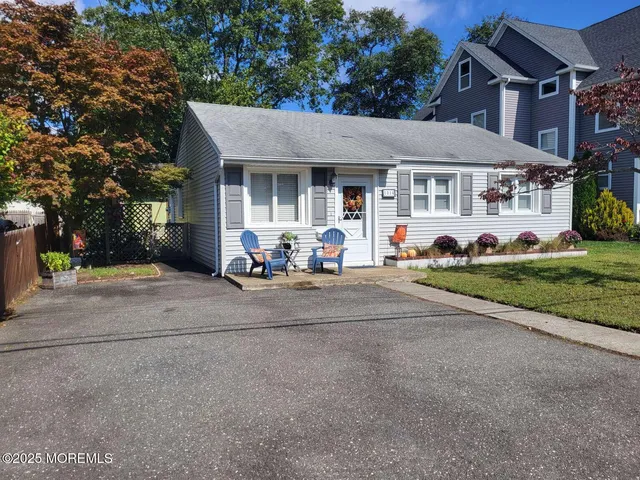 a view of a house with a patio and a yard