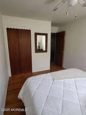 a bedroom with a bed and a painting on the wall