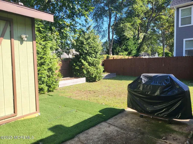 a view of a backyard with plants and outdoor seating