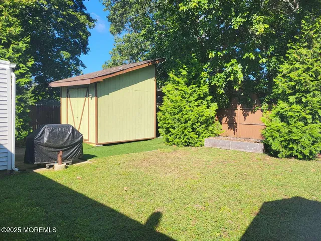 a backyard of a house with table and chairs