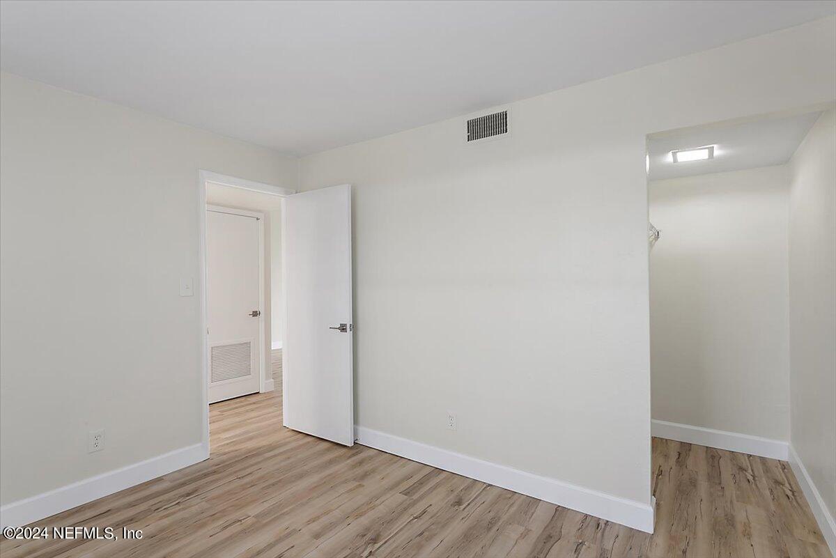 3100 Ocean Shore Boulevard, Unit 106 Ormond Beach, FL 32176 - Photo 11 of 21 a view of an empty room with wooden floor