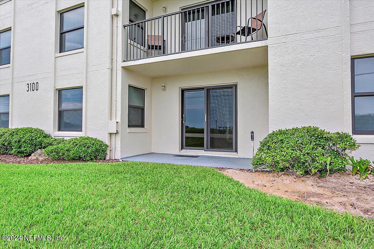 3100 Ocean Shore Boulevard, Unit 106 Ormond Beach, FL 32176 - Photo 14 of 21 front view of a house with a yard