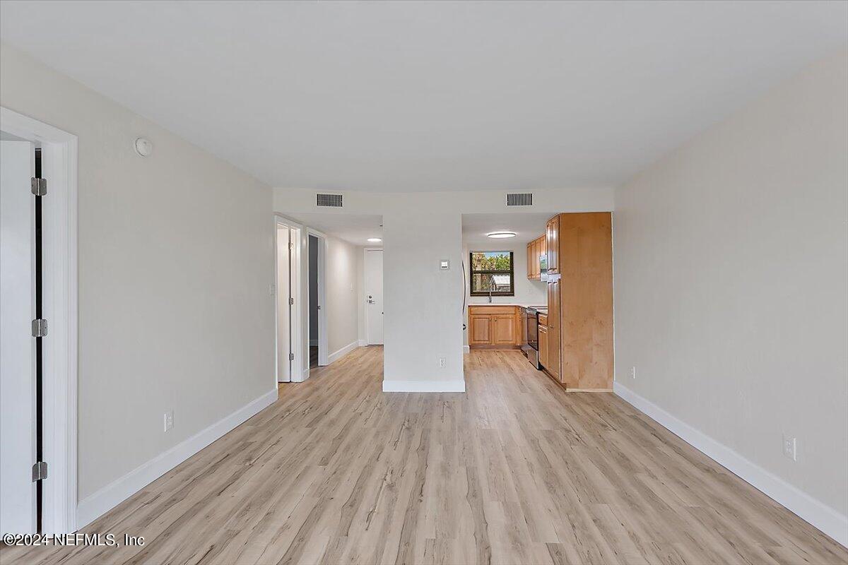 3100 Ocean Shore Boulevard, Unit 106 Ormond Beach, FL 32176 - Photo 3 of 21 a view of empty room with wooden floor