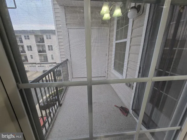 a view of staircase with railing and white walls