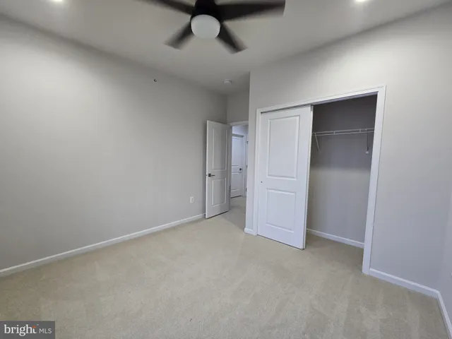 an empty room with a empty space and a ceiling fan