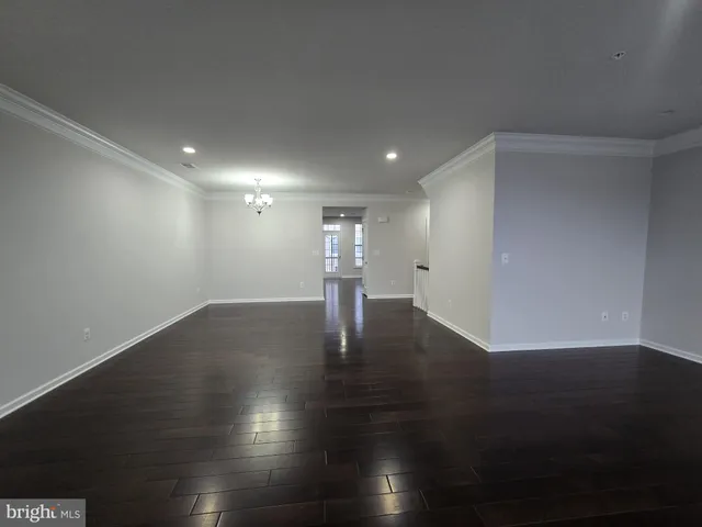 an empty room with wooden floor