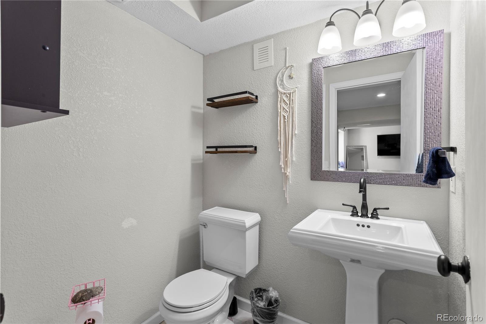 2212 Hyacinth Road Littleton, CO 80129 - Photo 35 of 44 a bathroom with a sink mirror and toilet