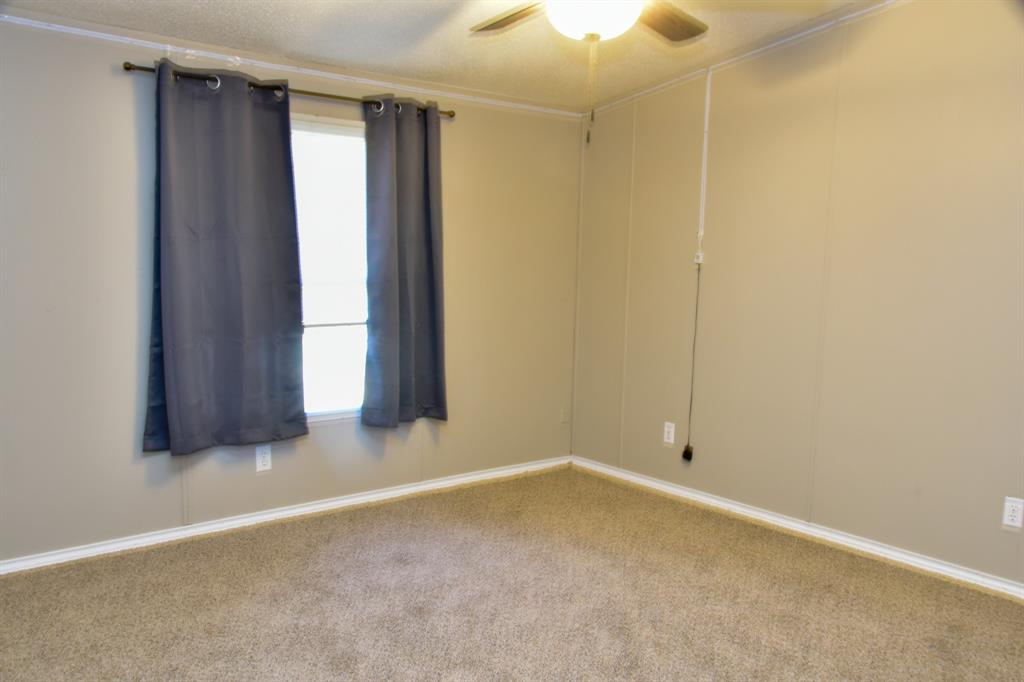 289 Belle Place Springtown, TX 76082 - Photo 14 of 17 an empty room with windows