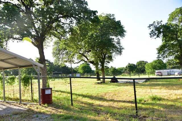 a view of swimming pool with trees in the background