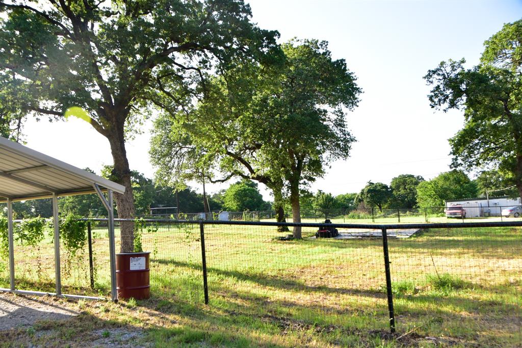 289 Belle Place Springtown, TX 76082 - Photo 5 of 17 a view of swimming pool with trees in the background