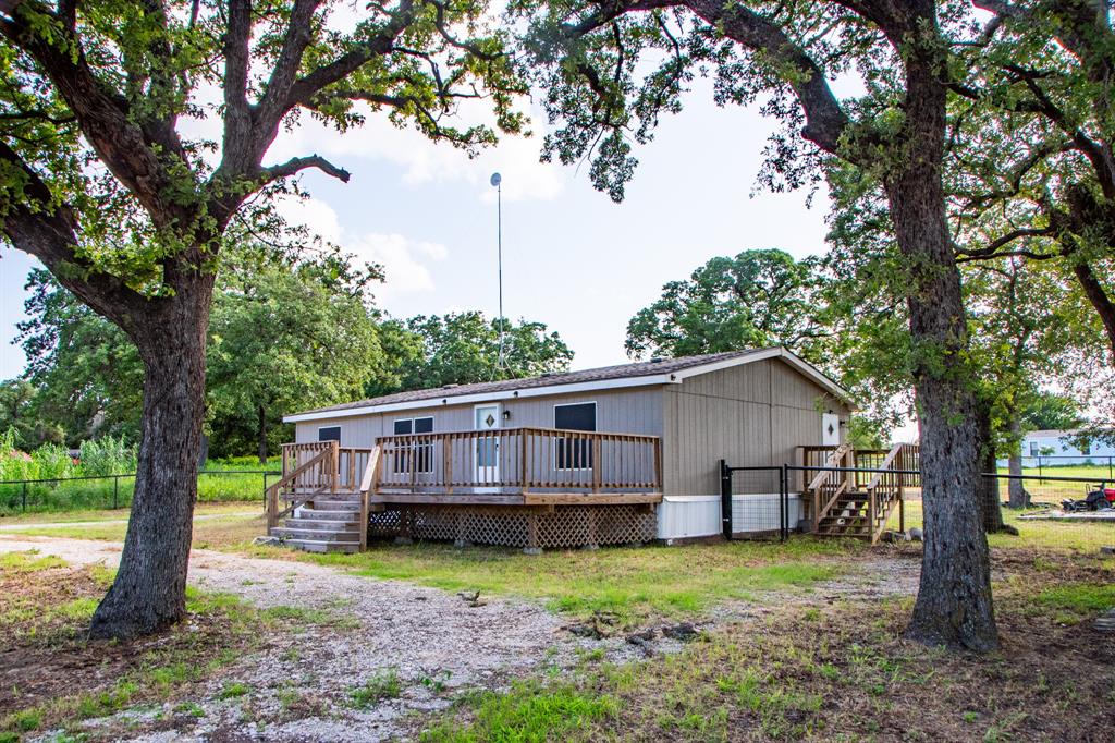 289 Belle Place Springtown, TX 76082 - Photo 7 of 17 a view of a house with backyard and trees
