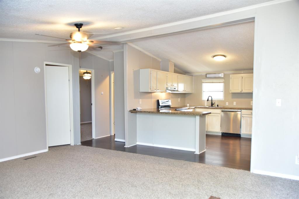 289 Belle Place Springtown, TX 76082 - Photo 10 of 17 a open kitchen with a refrigerator a stove top oven a chimney and a center island