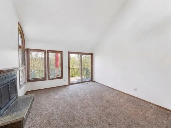 a bedroom with two beds and a large window