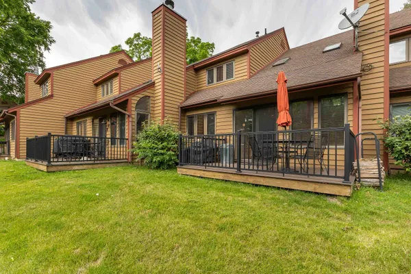 a bedroom with a bed and a night stand next to a window