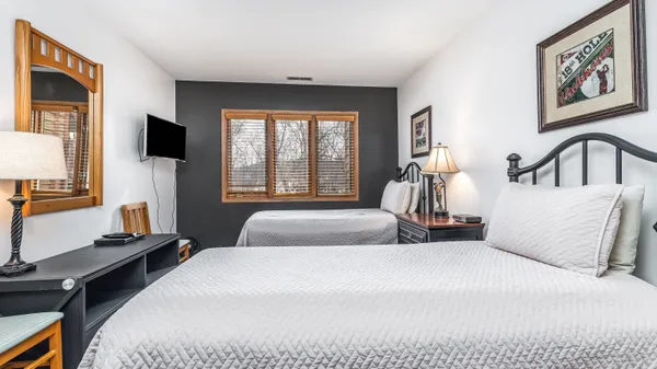 a living room with furniture a flat screen tv and a large window