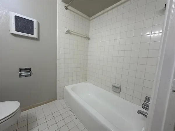 a bathroom with a toilet a sink and bathtub