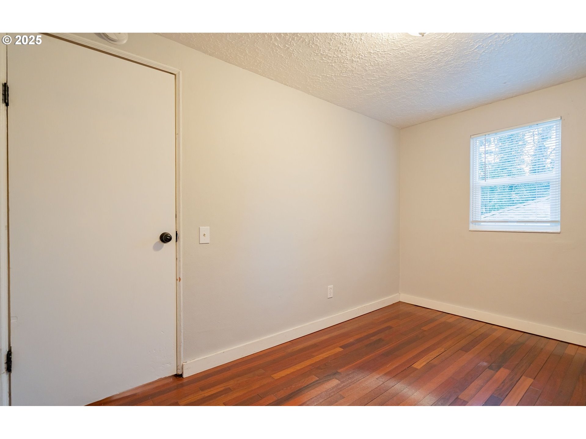 3915 I Street Vancouver, WA 98663 - Photo 7 of 20 a view of an empty room with wooden floor and a window