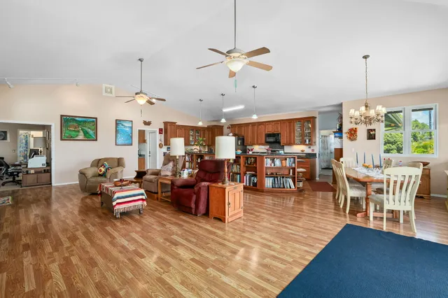 a living room with lots of furniture and chandelier