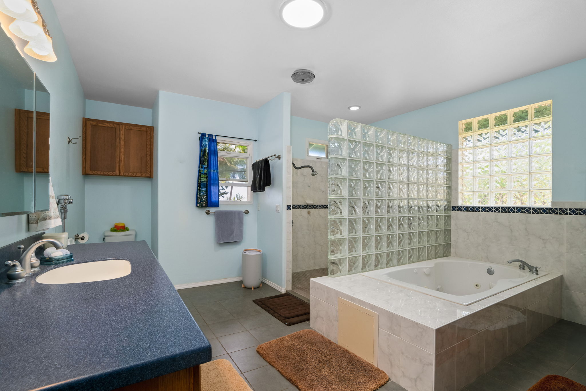 3837 Papalina Road Kalaheo, HI 96741 - Photo 19 of 26 a bathroom with a sink double vanity granite tub shower and a mirror