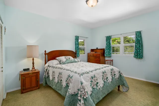 a bedroom with a bed and a lamp on table