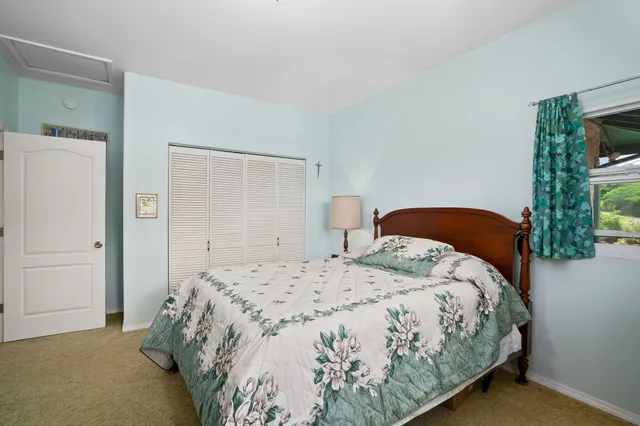 a bedroom with a bed and a mirror