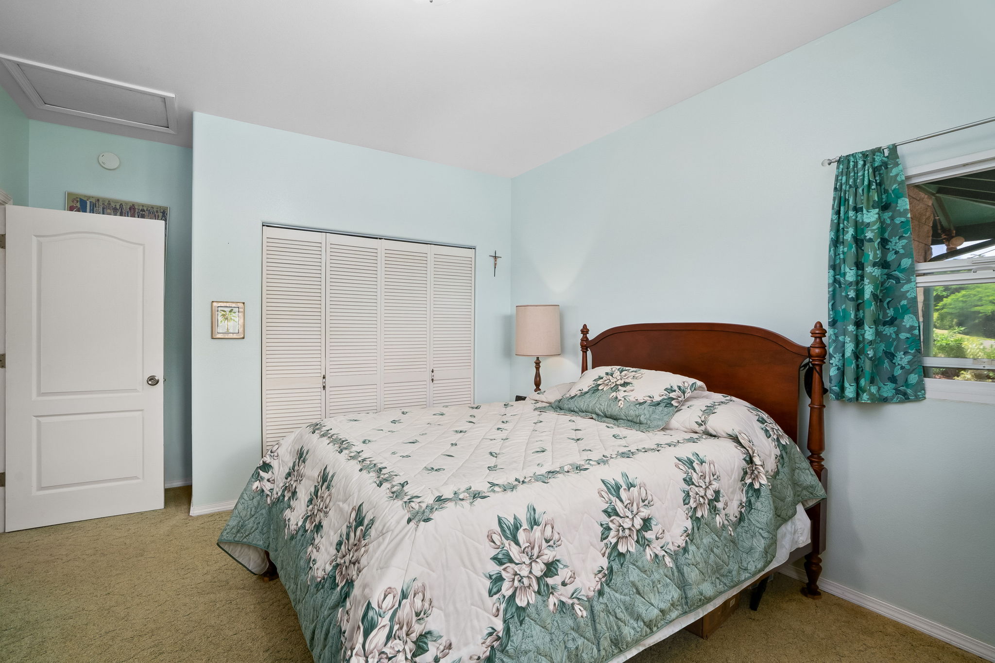 3837 Papalina Road Kalaheo, HI 96741 - Photo 24 of 26 a bedroom with a bed and a mirror
