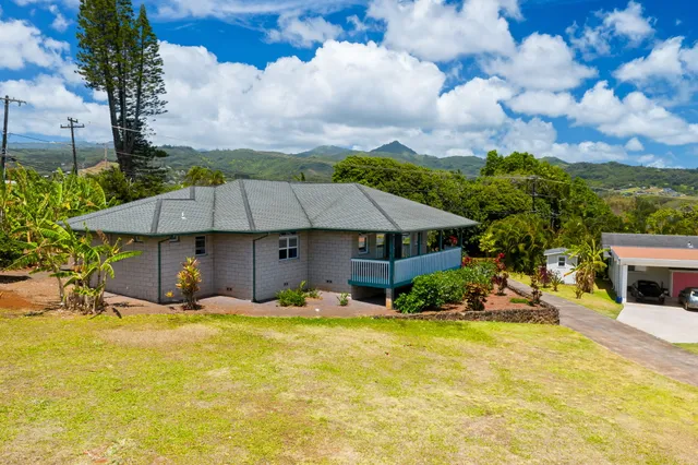 a backyard of a house with yard and outdoor seating