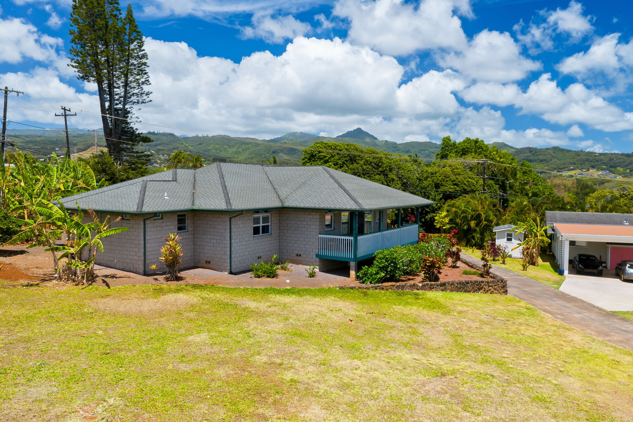 3837 Papalina Road Kalaheo, HI 96741 - Photo 3 of 26 a backyard of a house with yard and outdoor seating