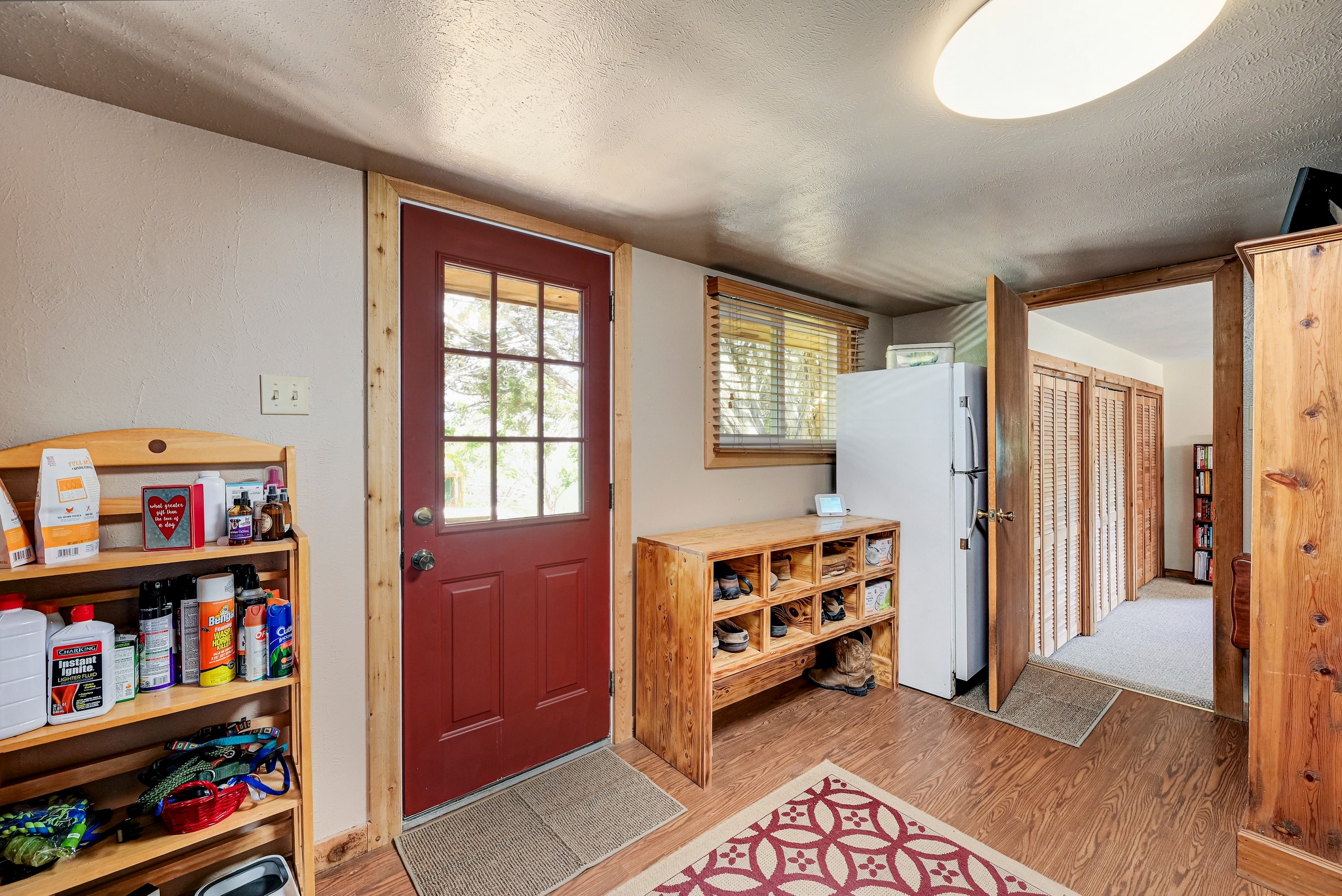 900 Box Canyon Road Wimberley, TX 78676 - Photo 24 of 40 This room serves as a mud room leading into the primary suite. The door leads out into the backyard fenced in area. There is another large closet in this space.