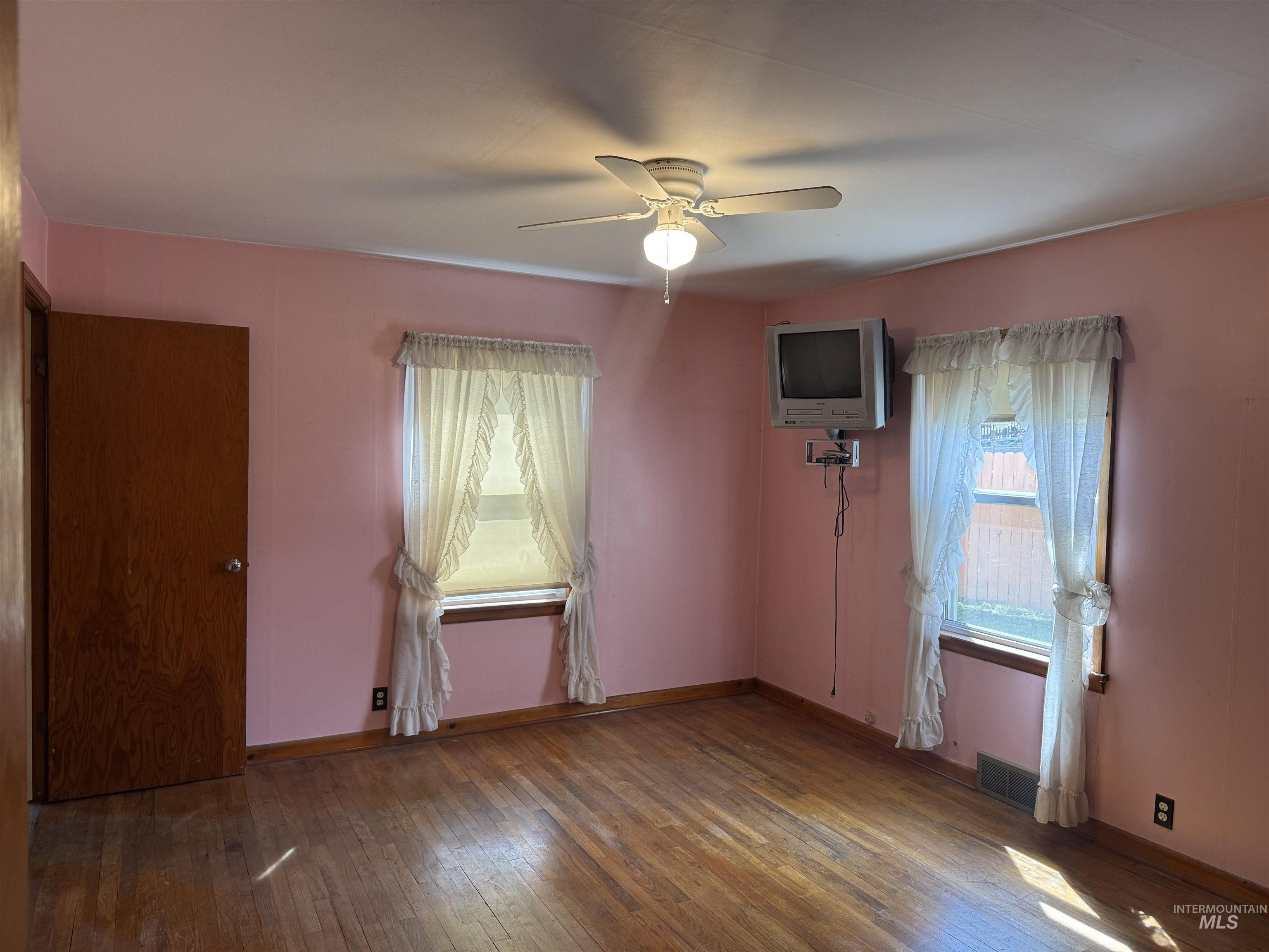 1109 3rd Street Kamiah, ID 83536 - Photo 14 of 21 Empty room with dark wood-style flooring and a ceiling fan