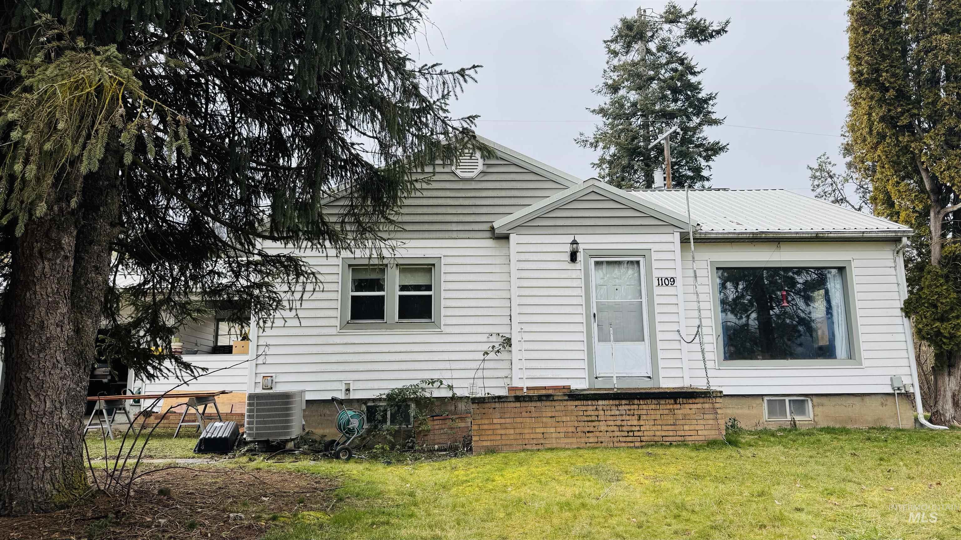 1109 3rd Street Kamiah, ID 83536 - Photo 2 of 17 View of front of house featuring a front yard and a metal roof