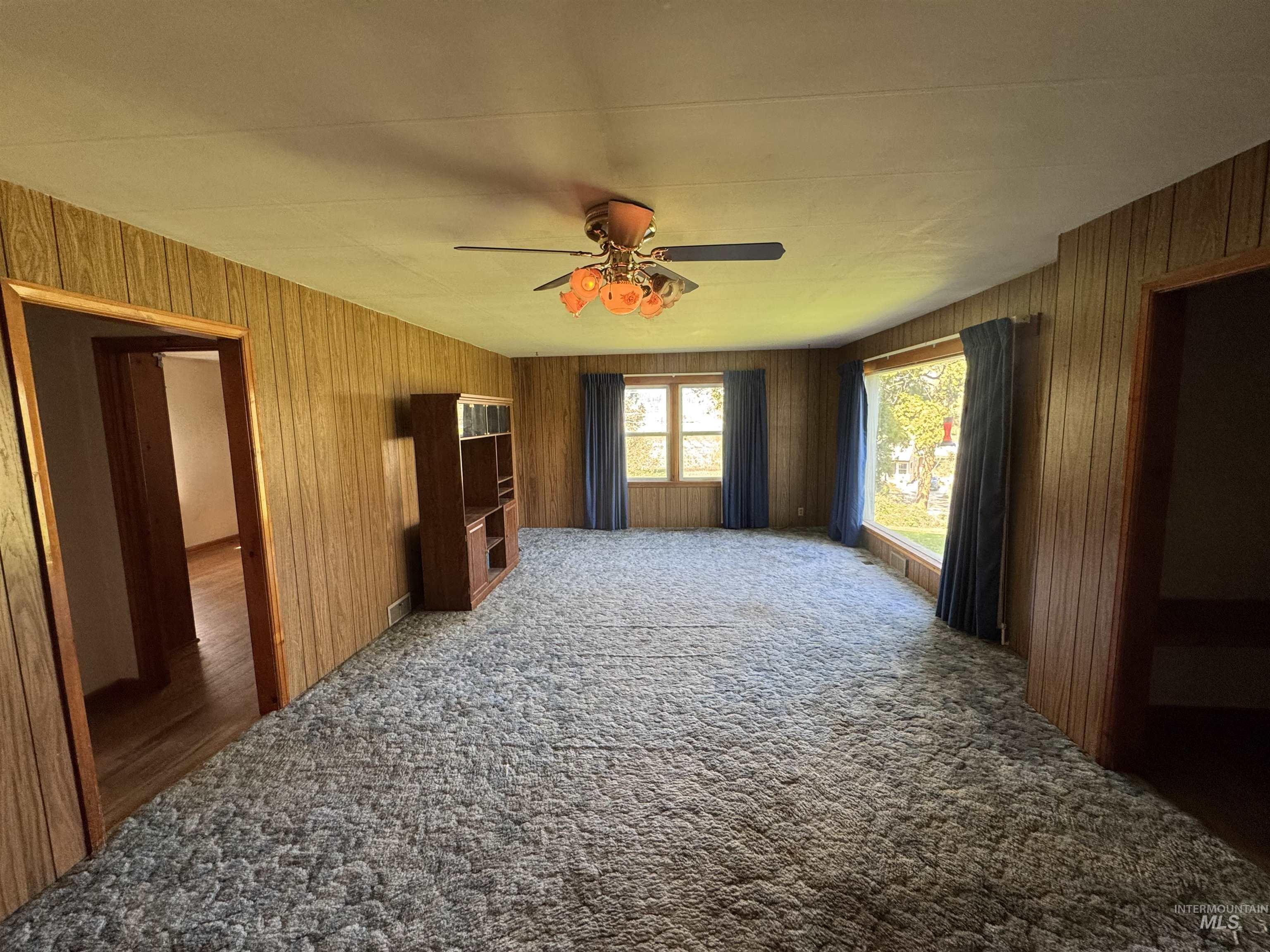 1109 3rd Street Kamiah, ID 83536 - Photo 9 of 21 Unfurnished living room with carpet flooring and ceiling fan