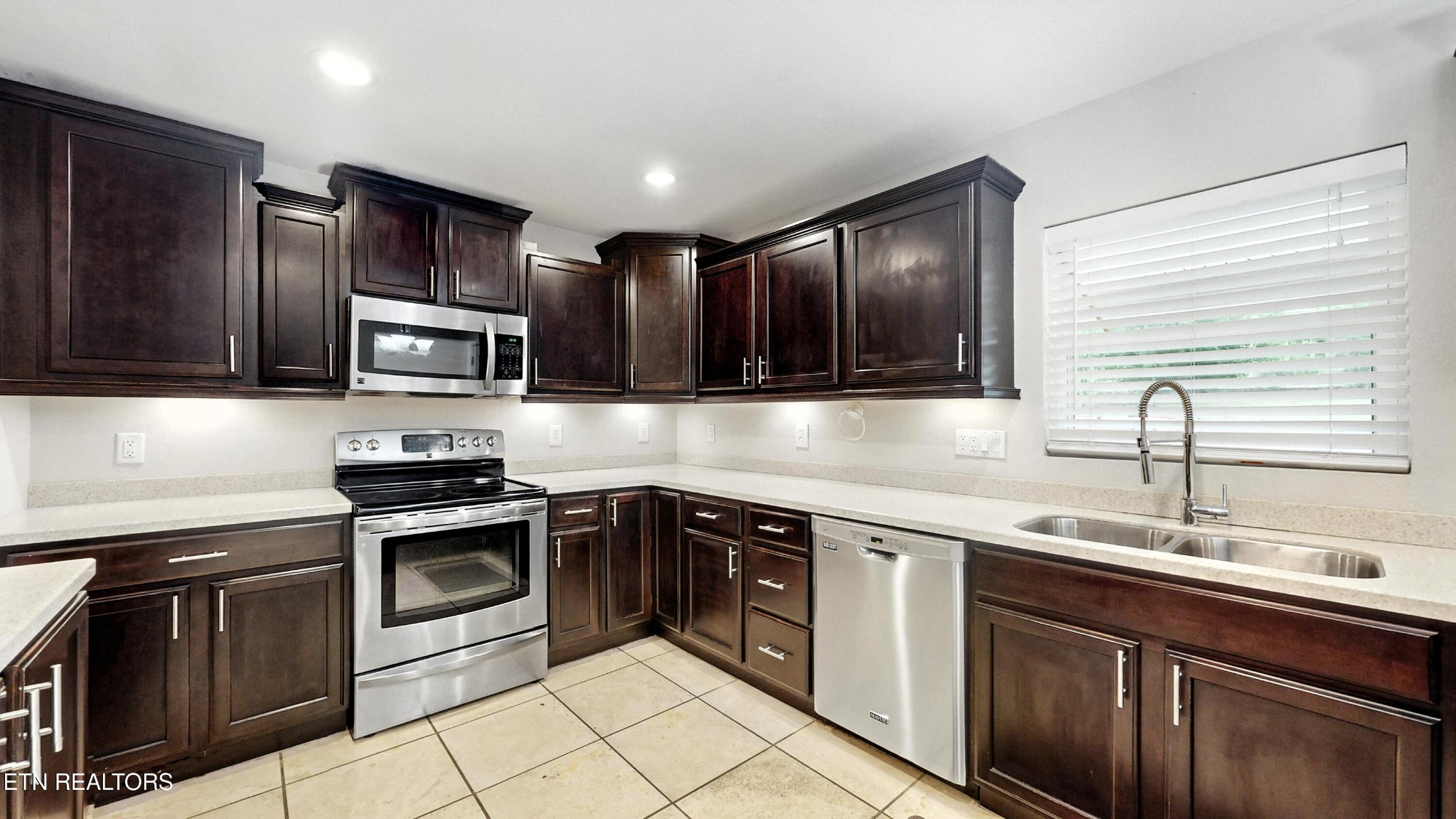 110 Ogden Circle Oak Ridge, TN 37830 - Photo 3 of 50 a kitchen with stainless steel appliances granite countertop a sink stove microwave and cabinets