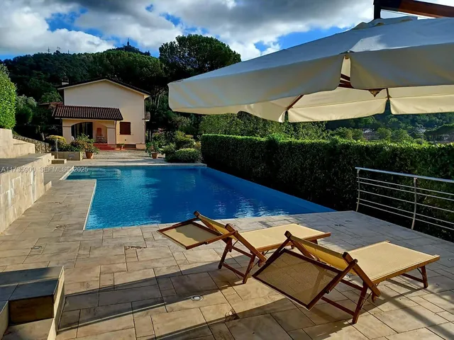 a view of a swimming pool with a lounge chairs