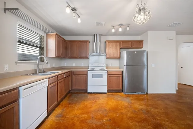 a kitchen with a refrigerator and a sink