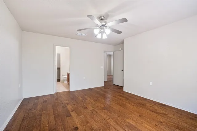 a view of an empty room and wooden floor