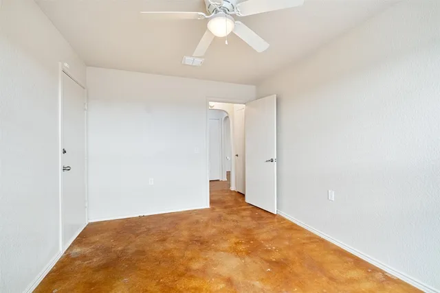 a view of a big room with closet and a chandelier fan