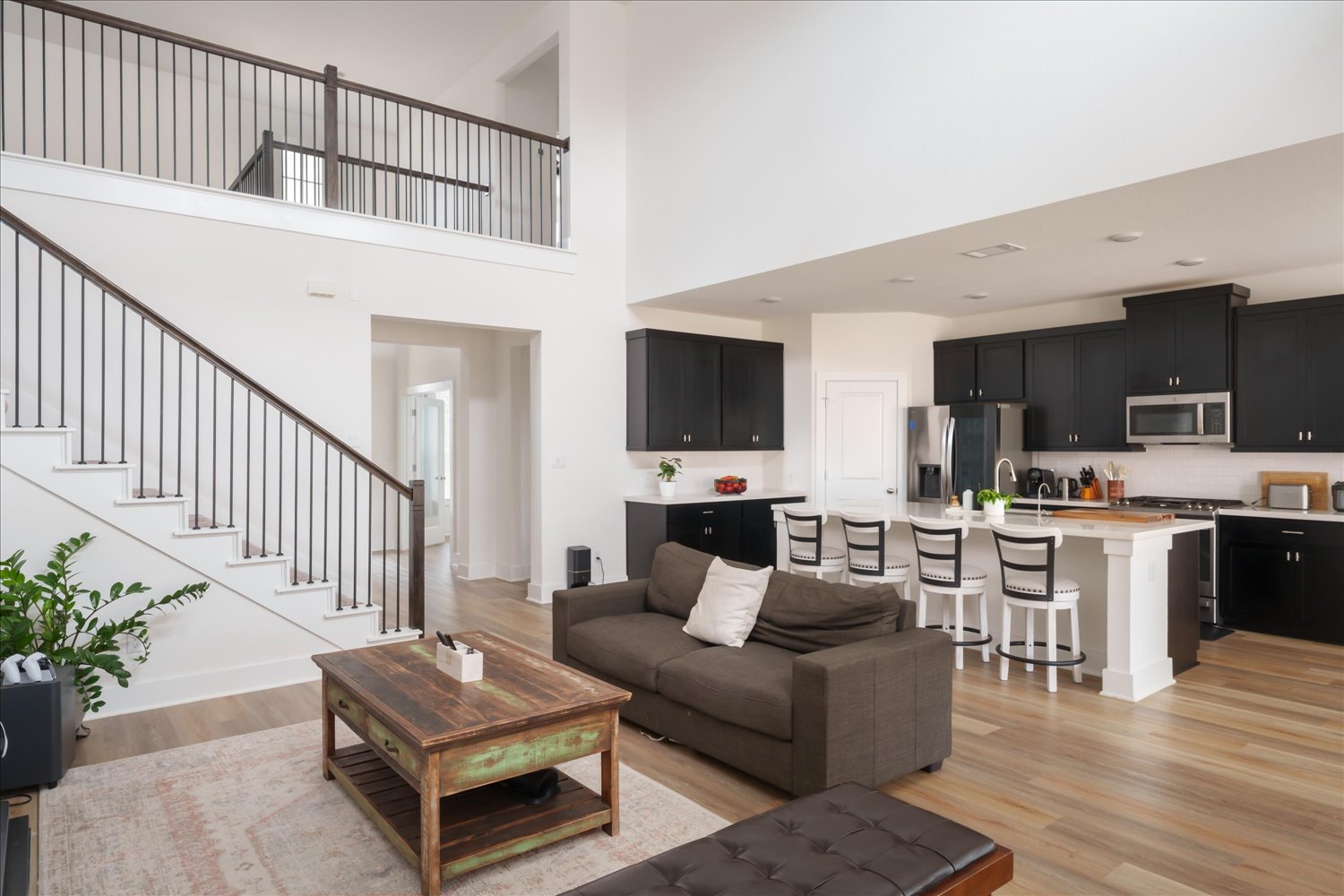 3120 Pale Rider Pass Leander, TX 78641 - Photo 8 of 34 Living area with light wood-style flooring and a high ceiling and windows