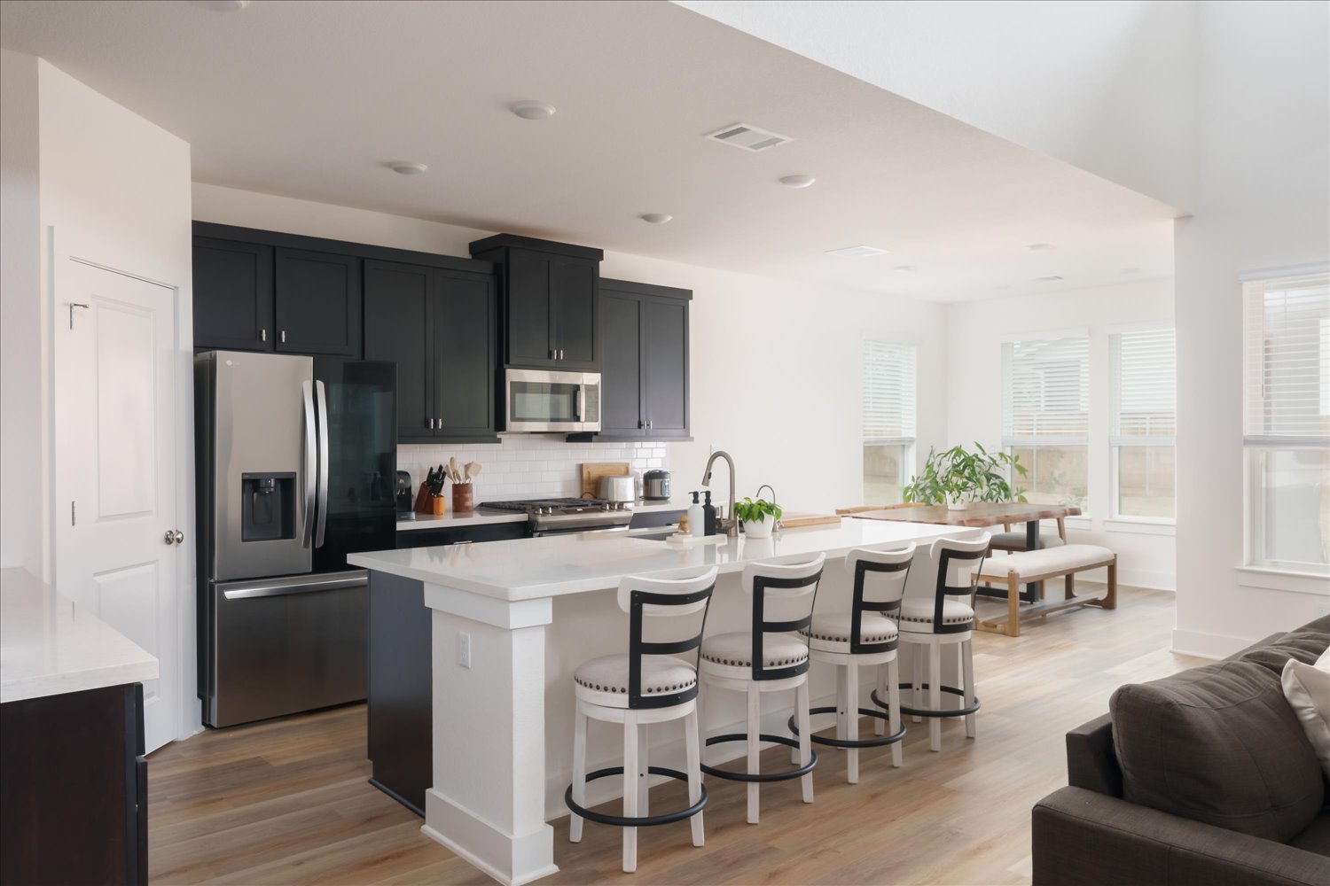 3120 Pale Rider Pass Leander, TX 78641 - Photo 10 of 34 Kitchen with stainless steel appliances, light wood-type flooring, tasteful backsplash, a center island with sink, and recessed lighting