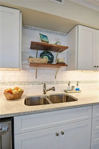 a kitchen with a sink and cabinets