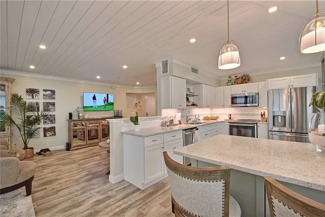 a large kitchen with a table and chairs