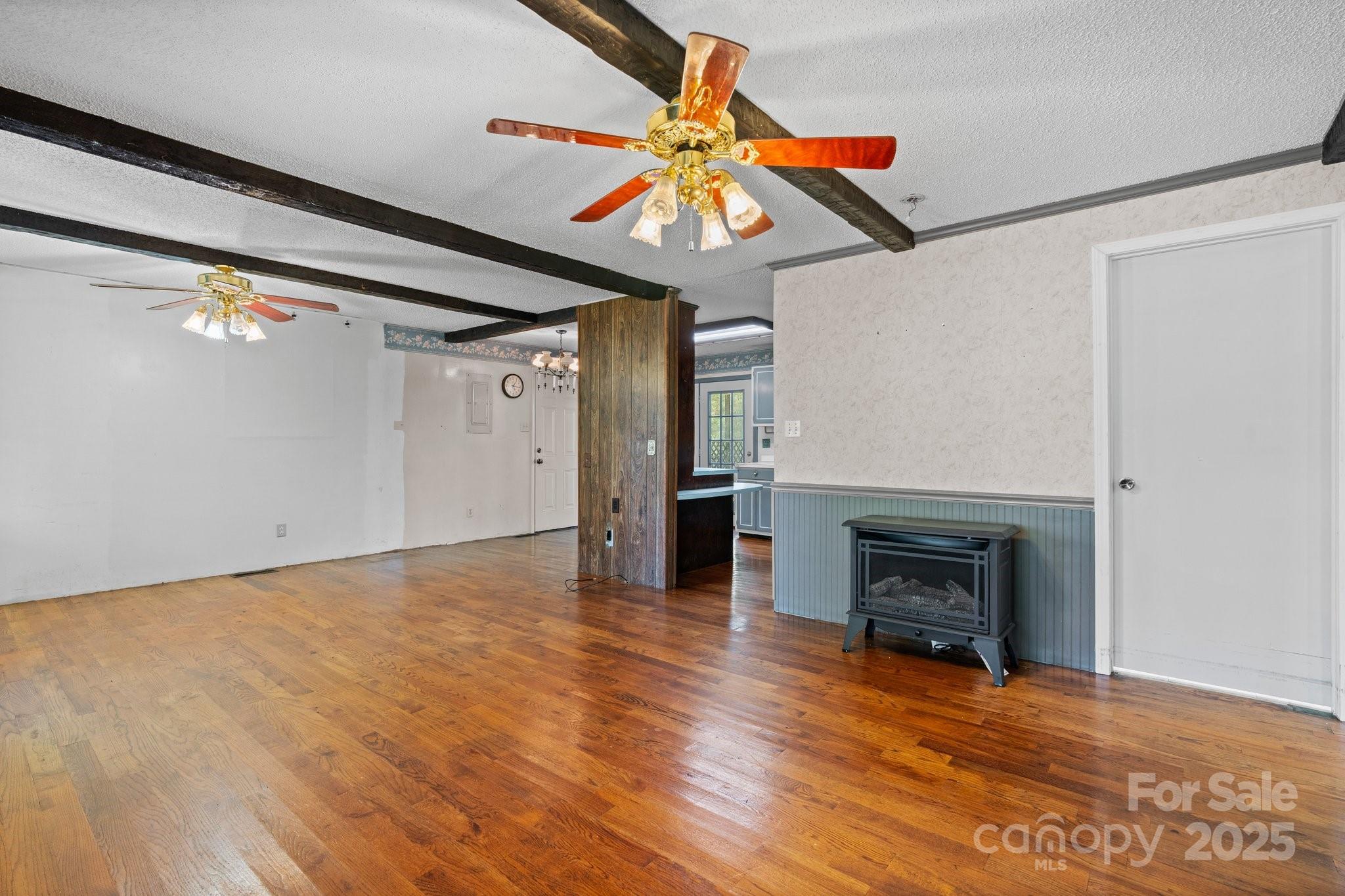 4067 Old Buff Road Hickory, NC 28602 - Photo 14 of 45 a view of an empty room with wooden floor fireplace and a window