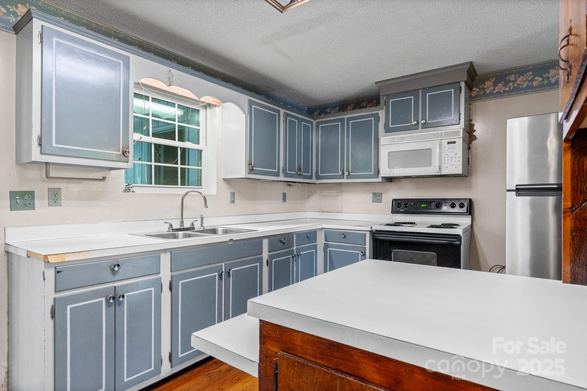 4067 Old Buff Road Hickory, NC 28602 - Photo 17 of 45 a kitchen with a sink stove and refrigerator